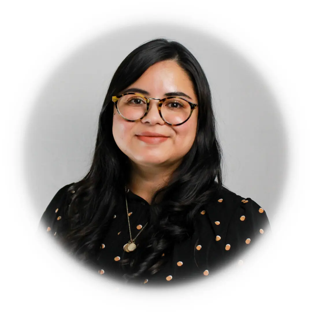 A woman with long black hair wearing glasses.